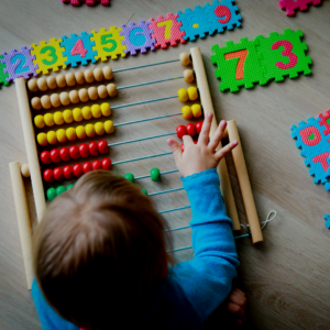 child playing with abacus and foam letters